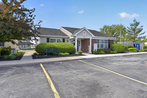 A building with a parking lot in front of it.
