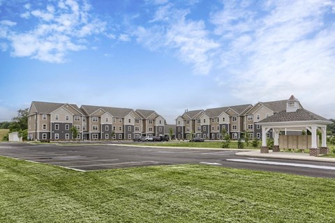 A large building with a parking lot in front of it.