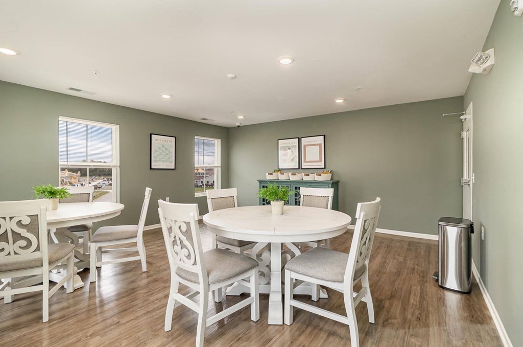 a dining room with a table and chairs
