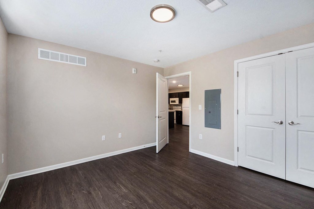 a renovated living room with white doors and wood flooring
