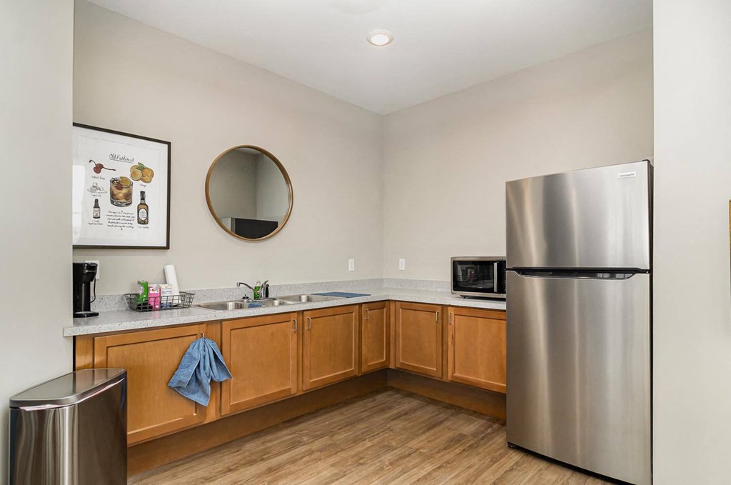 a kitchen with a stainless steel refrigerator and a sink
