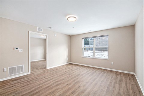 A room with a window showing a snowy scene outside.