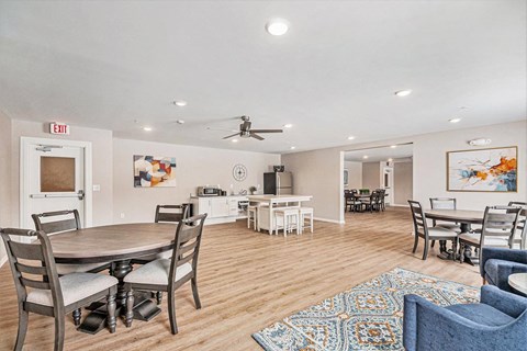 A dining room with a round table and chairs.