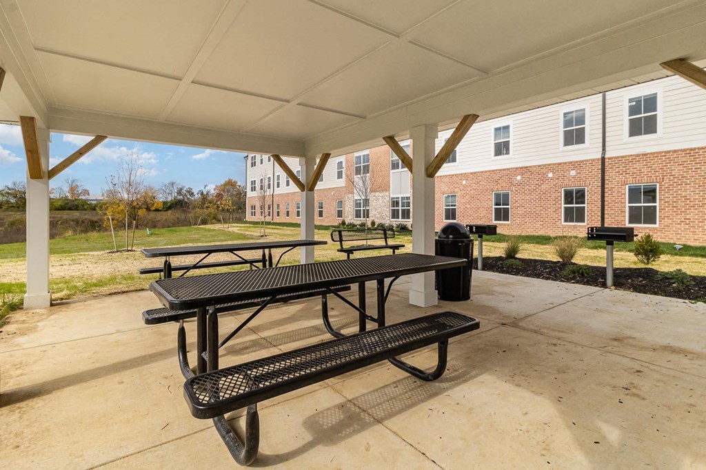 our picnic tables are under a covered pavilion with our building in the background