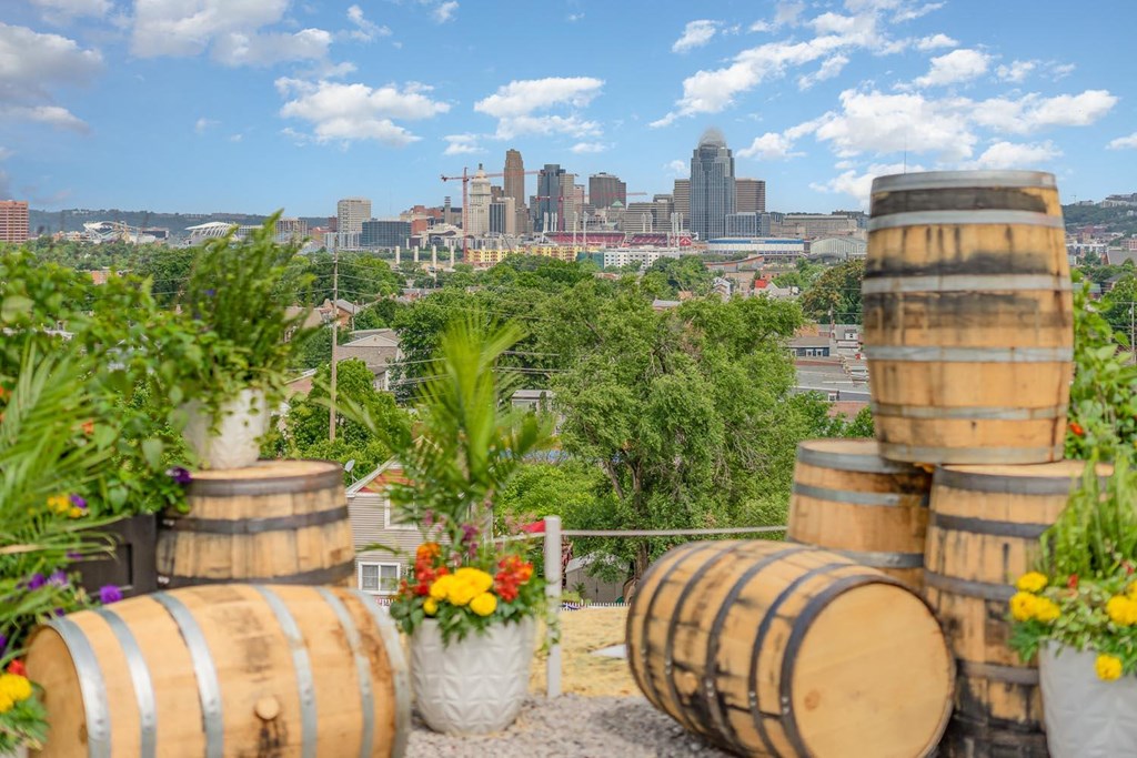 a cityscape in the background with wooden barrels in the foreground