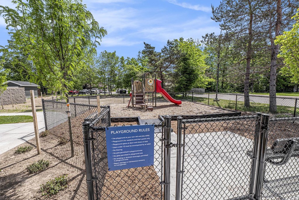 a park with a playground and a sign