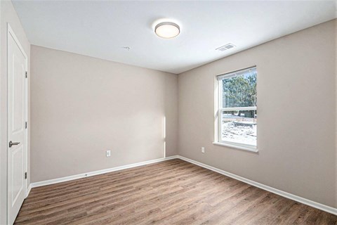 A room with a window and a door.