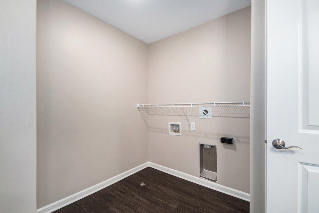 a empty room with a white wall and a white door