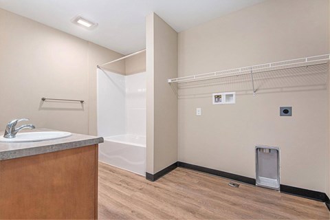 A bathroom with a sink, toilet, and a shower stall.