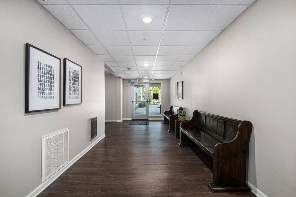 a long hallway with a couch and some pictures on the wall