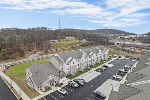 A parking lot with cars and a building in the background.