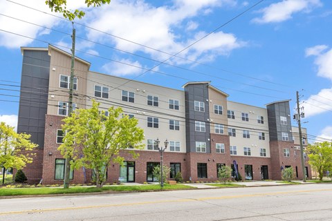 A large apartment building with a mix of brick and panel siding.