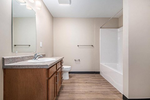 A bathroom with a sink, toilet, and bathtub.