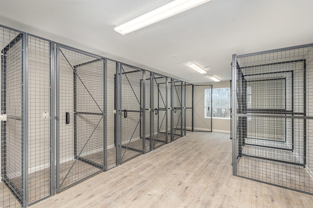 A room with a wooden floor and metal grid walls.