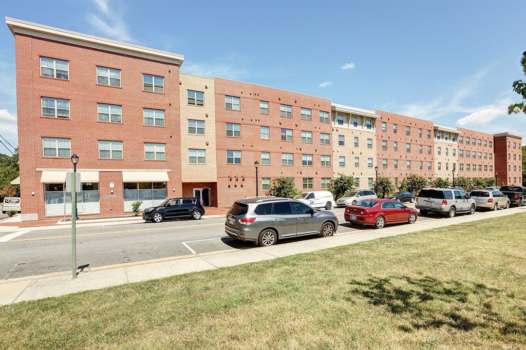 a large brick building with cars parked in front of it