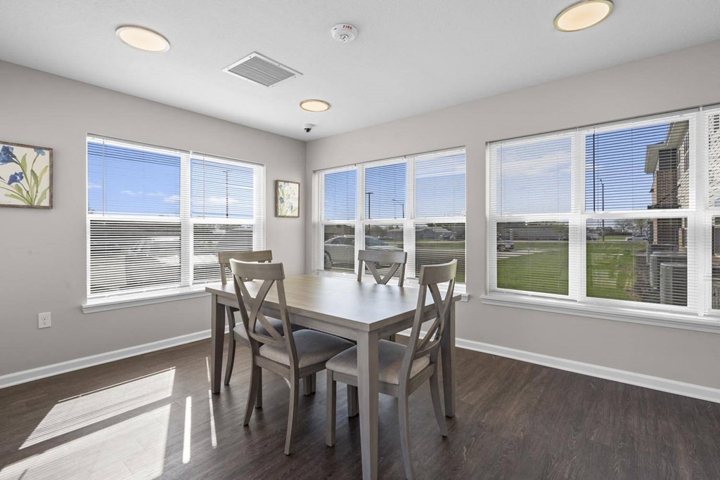 a dining room with a table and chairs