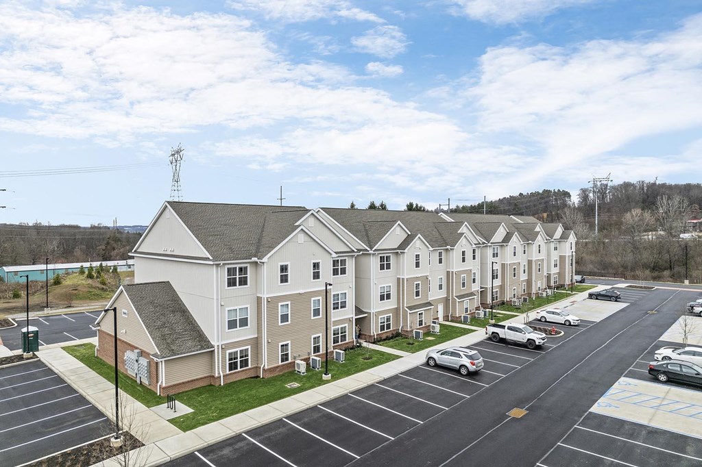A parking lot in front of apartment buildings.