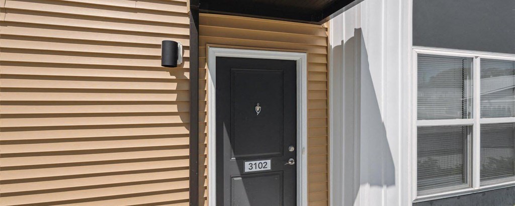 a house with a black door and white trim