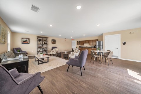 A living room with a grey couch and a brown table.