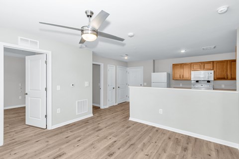 A white kitchen with a fan on the ceiling.