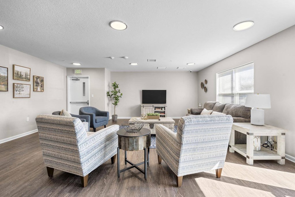 a living room with couches and chairs