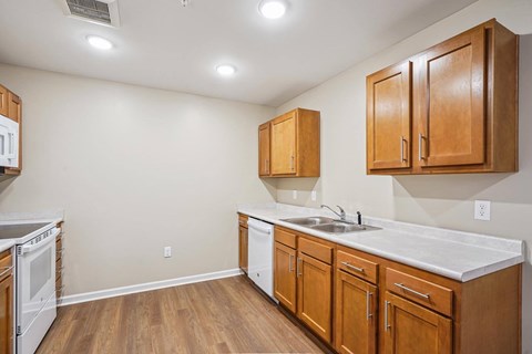 A kitchen with wooden cabinets and a white countertop.
