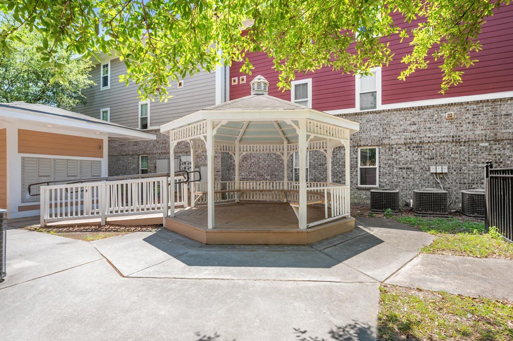 a gazebo in a yard in front of a building