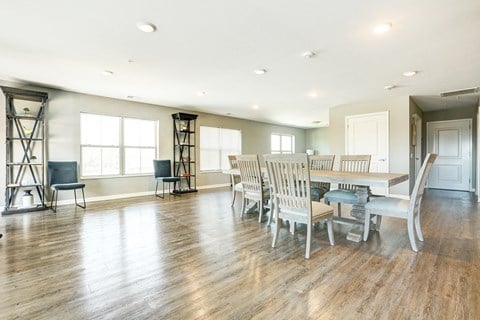 a large living room with a dining room table and chairs