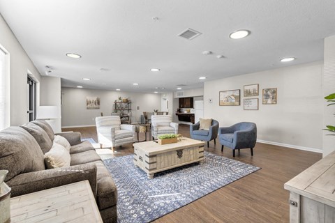 a living room with a couch and chairs and a table