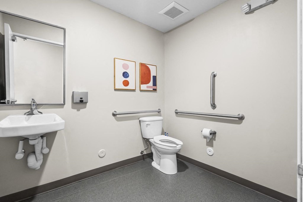 a bathroom with a toilet sink and mirror