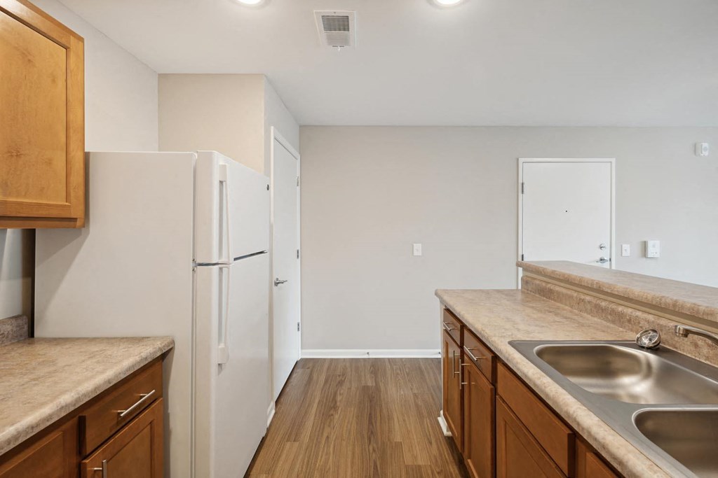 a kitchen with wooden cabinets and a white refrigerator