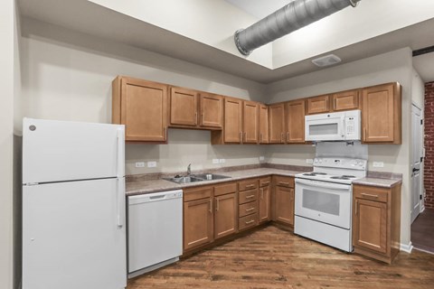 A kitchen with wooden cabinets and white appliances.