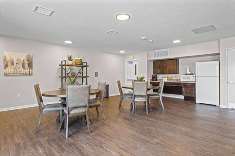 a dining room and kitchen with a table and chairs