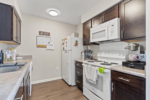 a kitchen with white appliances and wooden cabinets