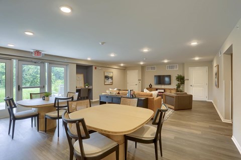 A dining room with a table and chairs.