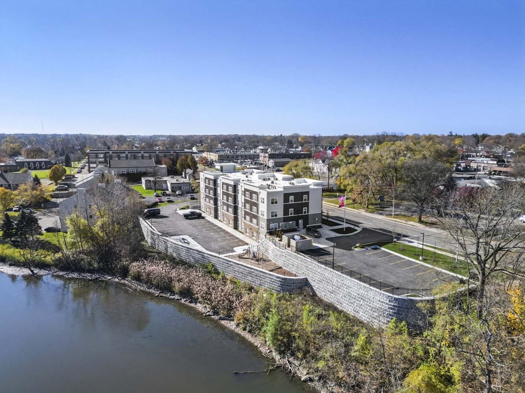 an aerial view of a building next to a river