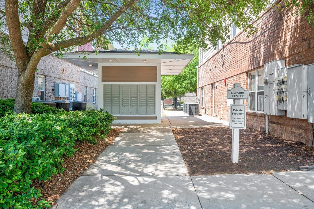 a sidewalk in front of a building with a parking meter