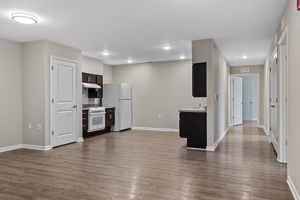 a kitchen and living room with a wood floor