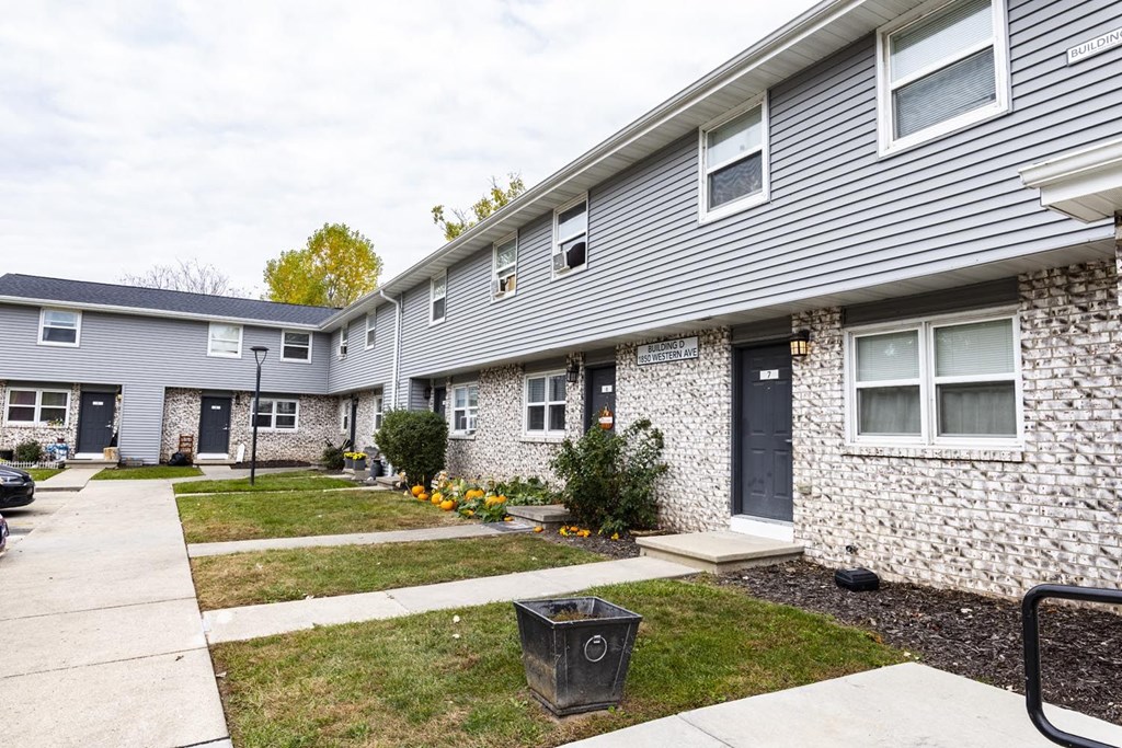 A grey house with a black door and windows.