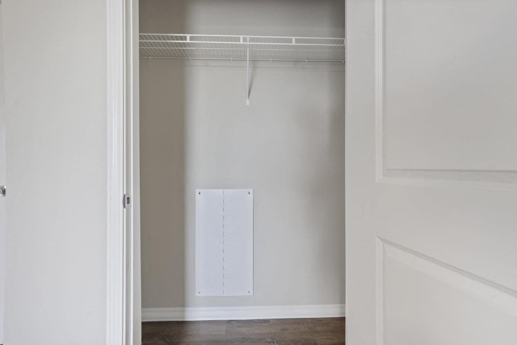 a white closet with a white door and a white wardrobe