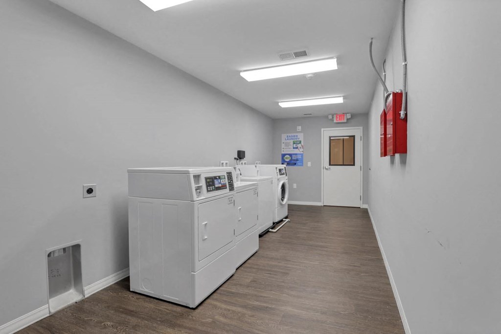 our laundry room is equipped with washers and dryers and a door to the