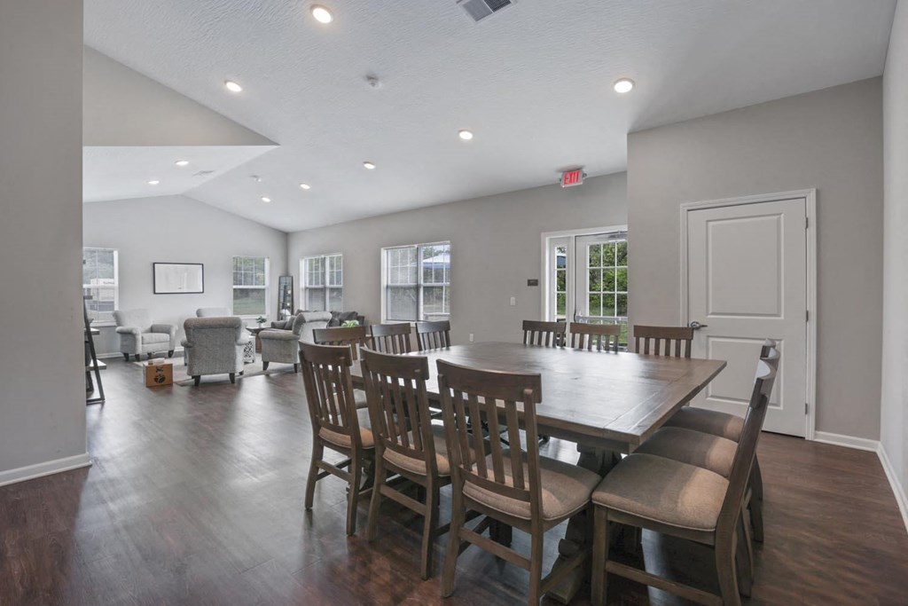 a dining room and living room with a large table and chairs