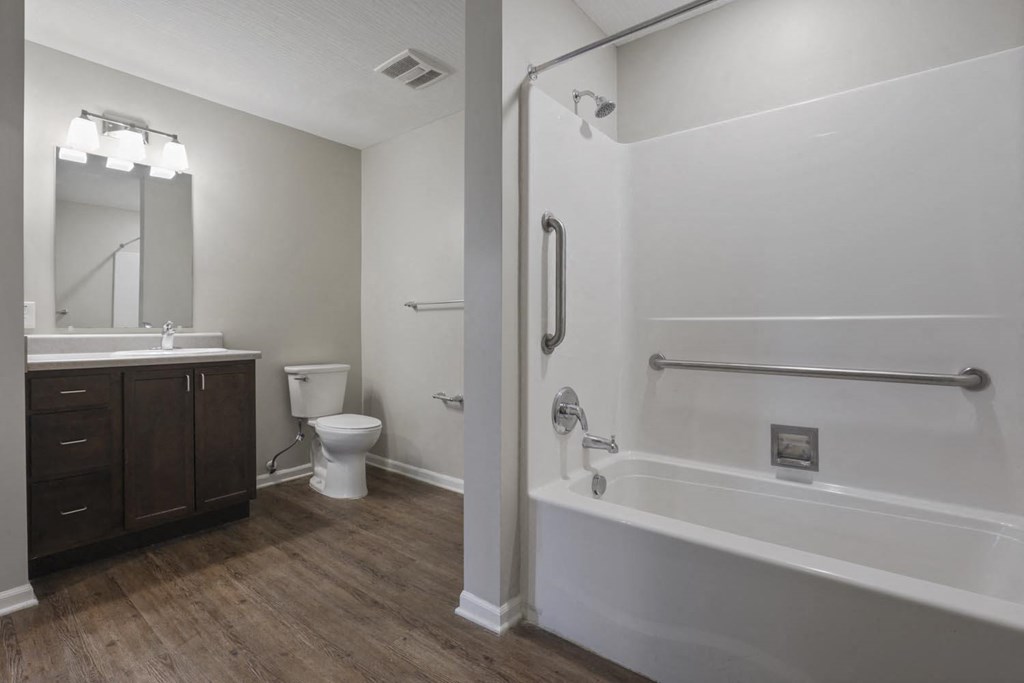 a bathroom with a shower and a toilet and a sink