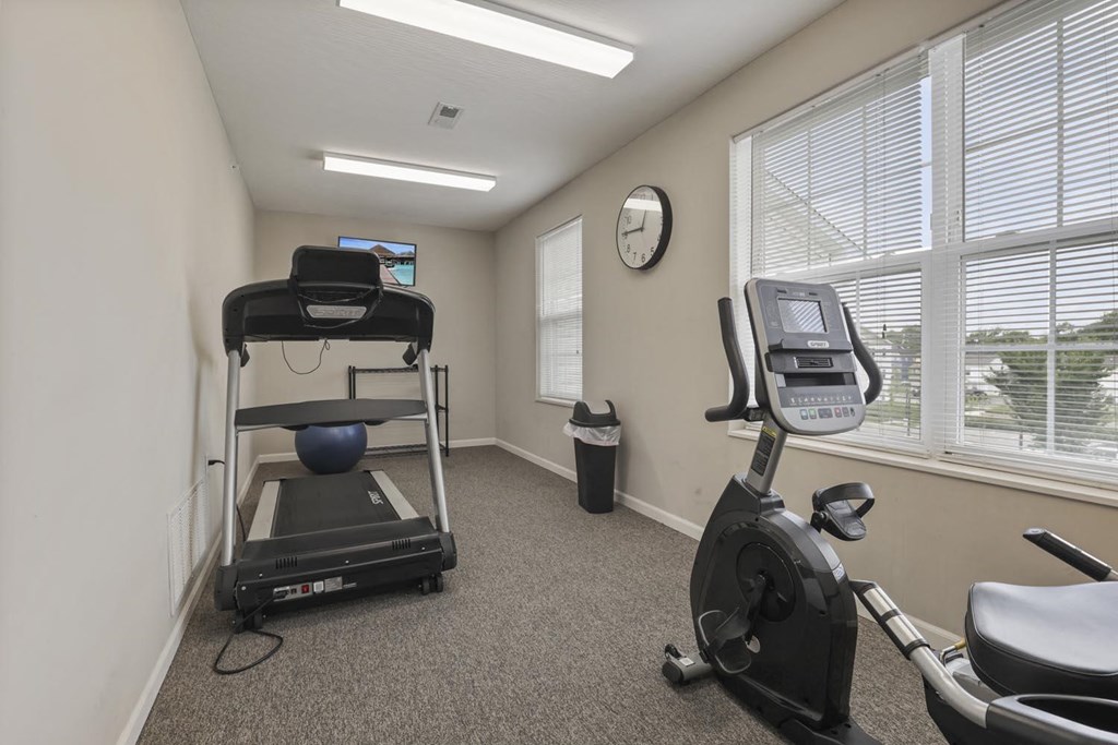an exercise room with an exercise bike and a window