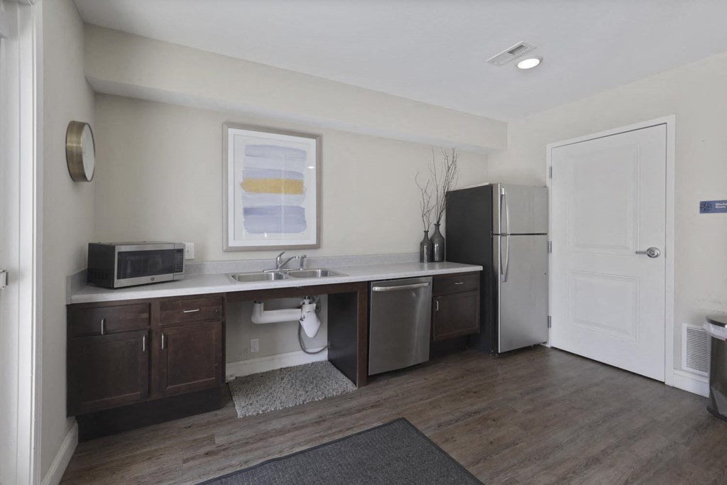 a kitchen with stainless steel appliances and a refrigerator