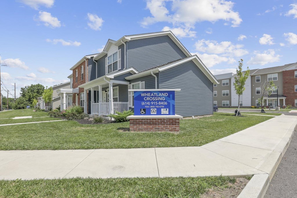 a blue sign in front of an apartment building