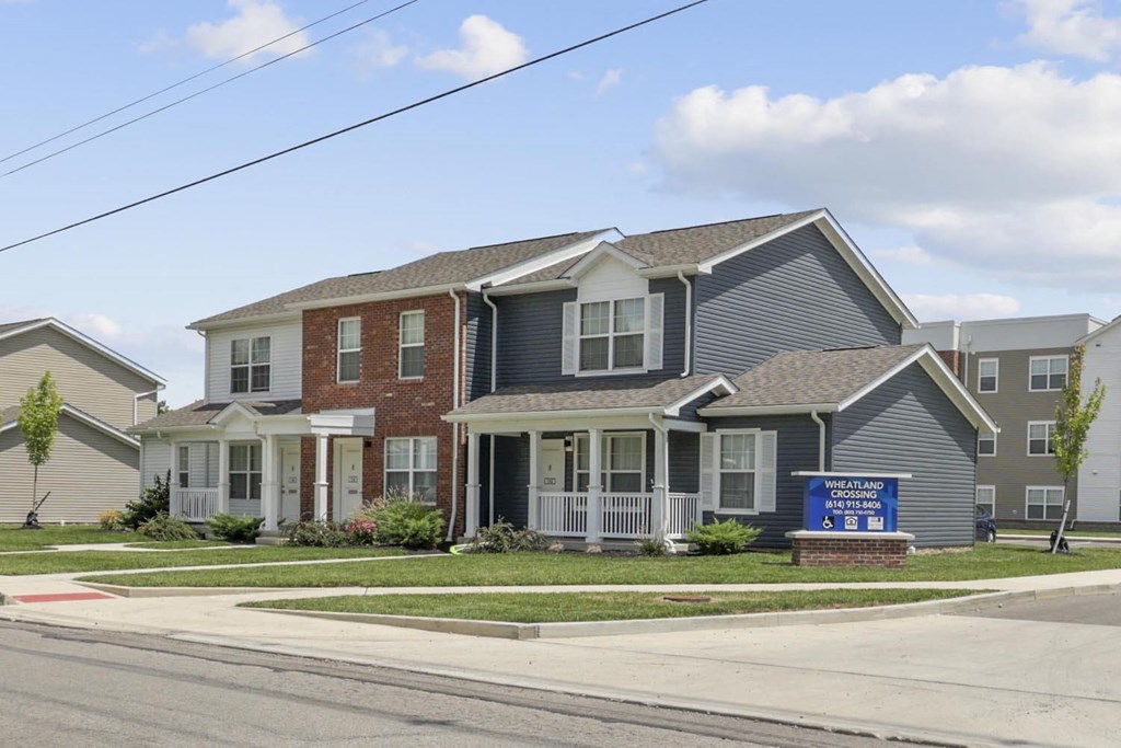 a home for sale on the corner of a street
