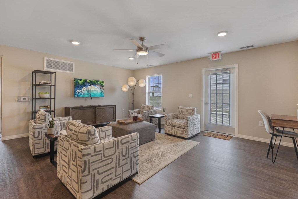 a living room with furniture and a ceiling fan