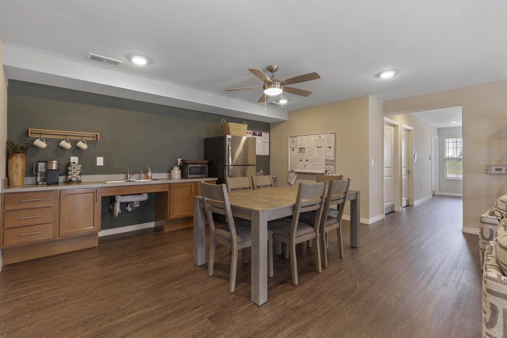 a kitchen and dining room with a table and chairs