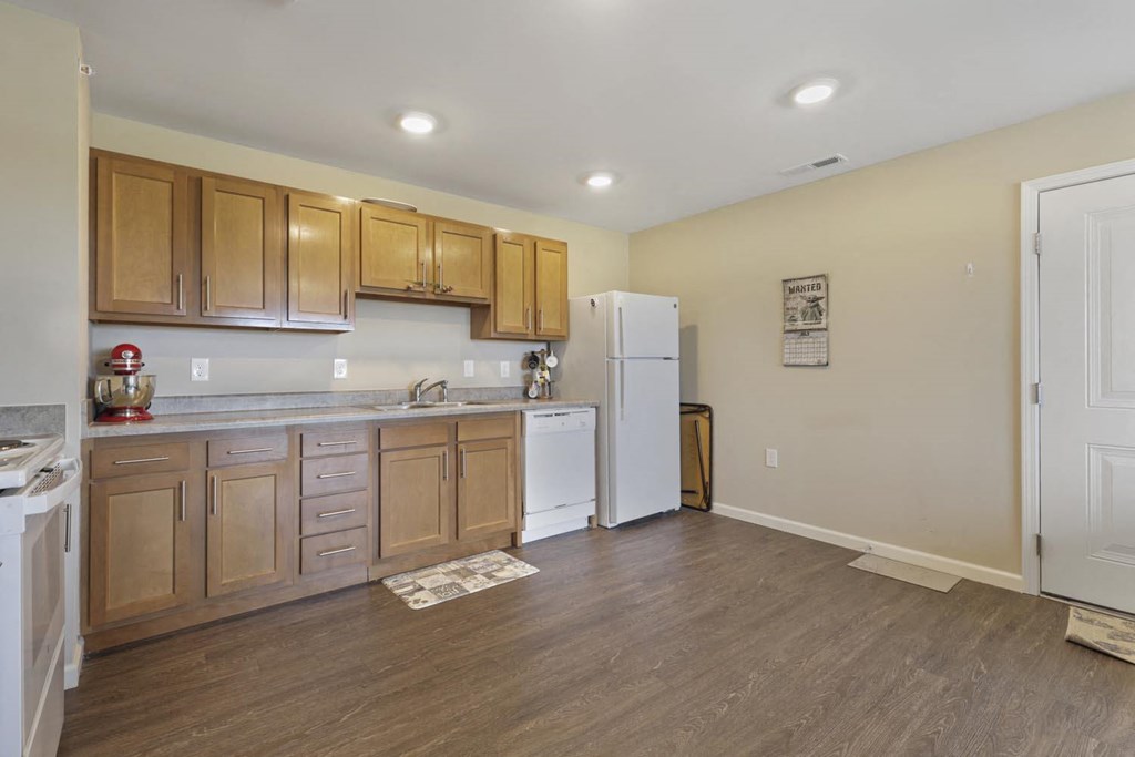 a kitchen with wooden cabinets and a white refrigerator